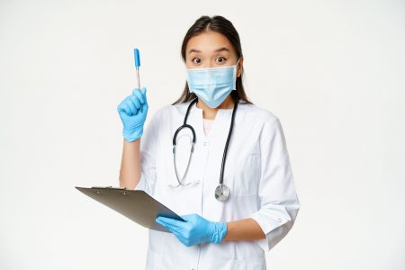 excited-female-doctor-asian-physician-holding-clipboard-raising-pen-up-found-solution-idea-standing-medical-face-mask-white-background