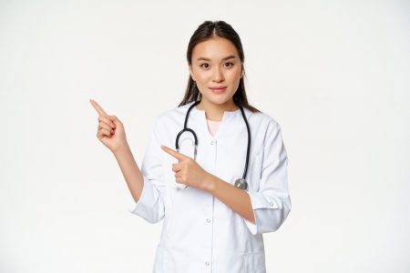 portrait-female-nurse-medical-uniform-pointing-fingers-left-showing-hospital-related-content-healthcare-information-aside-white-background